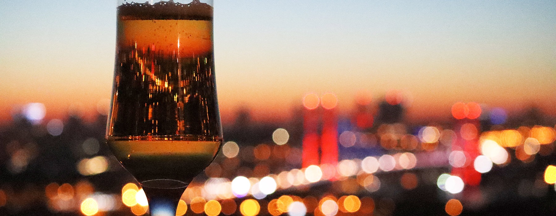 champagne glass with city view in background